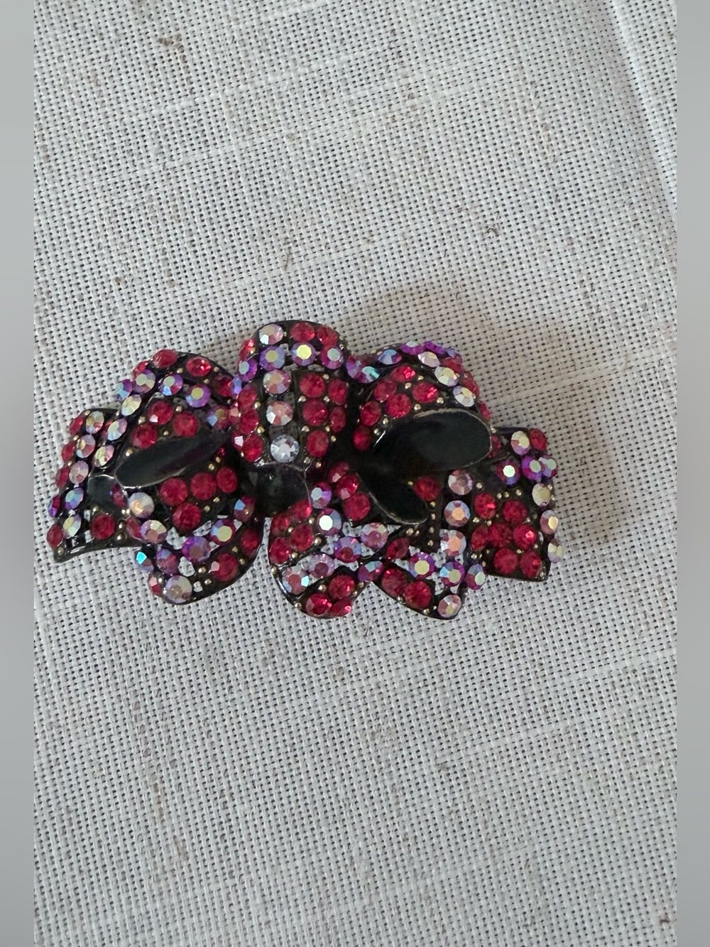 red rhinestone bow hair claw clip embellished with sparkling red and aurora bore